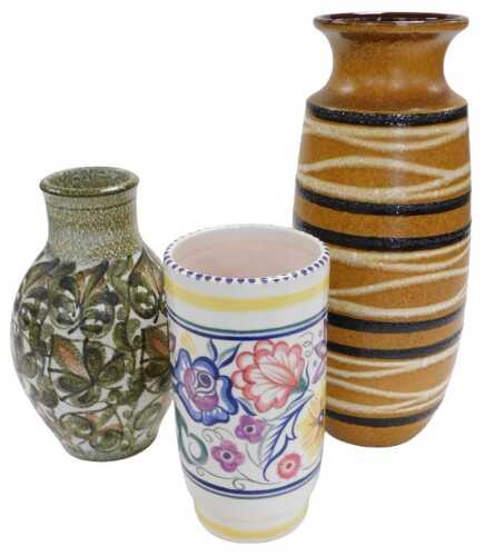 A Poole pottery vase, of cylindrical form, traditionally painted with flowers, 25cm high, a West...