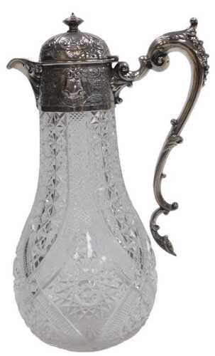 A Victorian cut glass and silver mounted claret jug, with silver handle and hinged lid, embossed...
