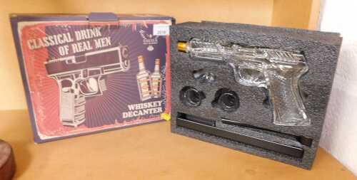 A novelty handgun whiskey decanter, boxed.