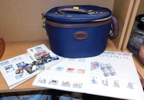 Two QEII stamp albums, together with a canvas travel bag. (3)