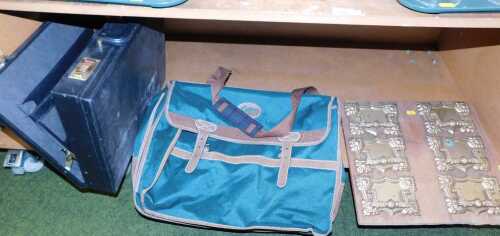 A black leather briefcase, a Cotton Traders over-the-shoulder bag, and a wooden plaque with door...
