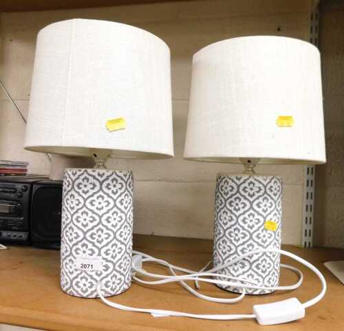 A pair of The Range table lamps, with grey and white eincised floral decoration, together with...