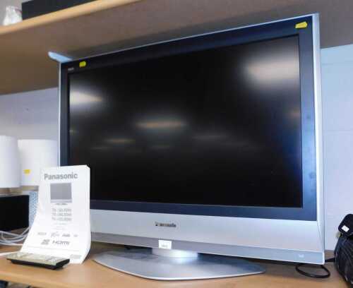 A Panasonic 31 inch TX-32LXD60 television, with manual and remote.