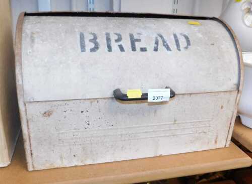 A cream painted metal bread bin, with a domed lid, stamped "Bread".