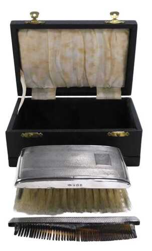 An Elizabeth II silver backed hairbrush, with engine turned decoration, rectangular reserve,...