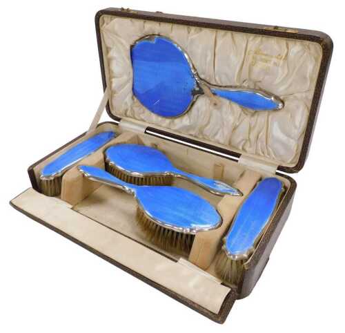 A George V silver and blue guilloche enamel five piece dressing table set, comprising of a pair...