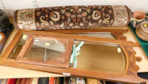 A pair of mahogany framed mirrors, with a scroll and leaf design to the top, and bevelled glass...
