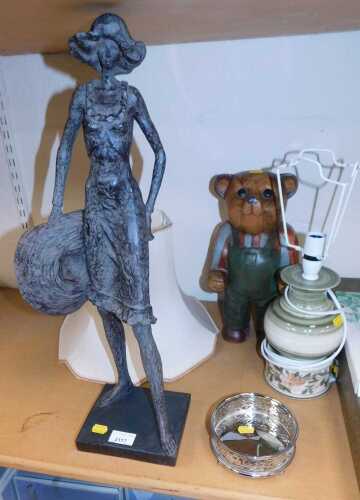 A bronzed plaster figure of a standing lady with a hat, 57cm high, together with a wooden bear...