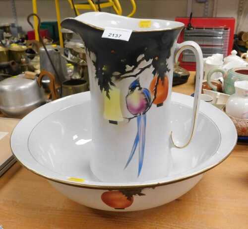A Midwinter Burslem wash jug and bowl, decorated by a bird with yellow and orange lanterns...
