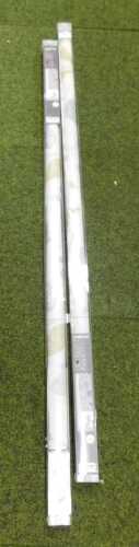 A pair of Colours Boreas blackout roller blinds, on a cream background with a leaf and floral...
