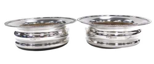 A pair of Elizabeth II silver wine coasters, with a gadrooned rim, Birmingham 1973, 15.61oz all...
