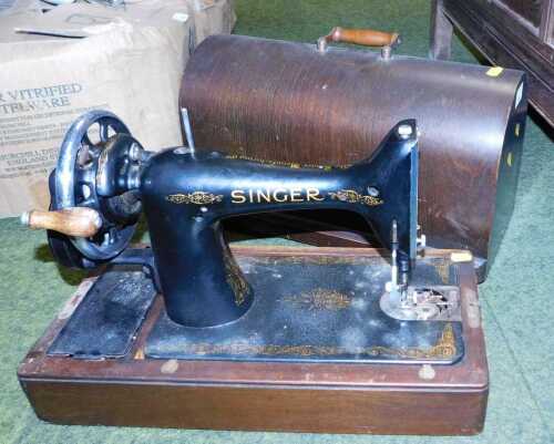 A Singer sewing machine, in a wooden case, model number ED881836.