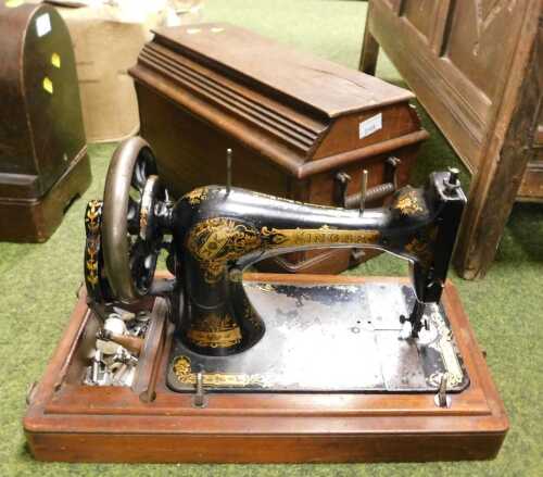 A Singer sewing machine, in a wooden case, model number J322804.
