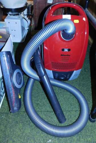 A Miele compact C2 Cat and Dog Powerline hoover, model SDBF4, with attachment.