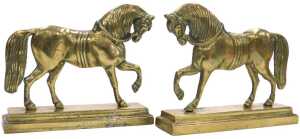 A pair of 19thC brass hearth ornaments, each cast in the form of a horse, on a stepped...