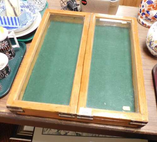 A glass fronted double door pine display cabinet, 53.5cm high, 45.5cm wide.