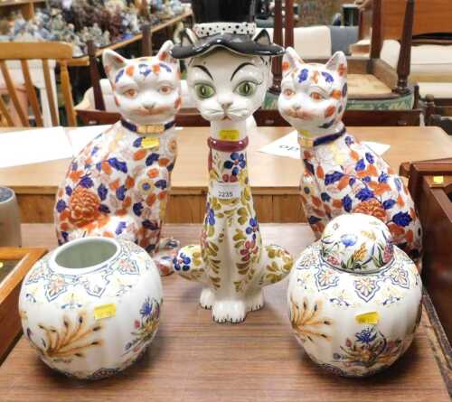 A group of ceramics, to include two Chinese cats, with floral motifs, together with a pair of...