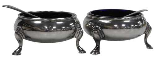 A pair of George VI silver salts, with blue glass liners, raised on hoof feet, London 1938,...