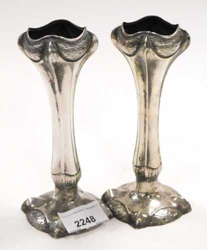 A pair of Art Nouveau silver plated bud vases, in a trumpet design, on stylised claw-foot bases....