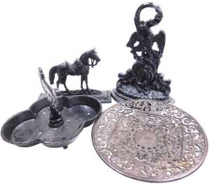 A 19thC black painted cast iron doorstop, modelled in the form of a hoho bird, above Rococo...