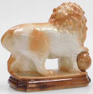 A pair of 20thC Staffordshire pottery lions, each modelled resting a front paw on a ball, on a... - 2