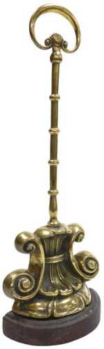 An early Victorian brass and iron doorstop, cast with scrolls, with a loop handle, 28cm high.