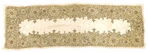 An early 20thC Indian cream silk table runner, with silver and gold wirework floral embroidery,...