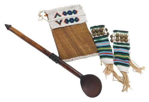 A Zulu Izimpontshi woven grass and beadwork spoon pouch, together with a Zulu carved wooden...
