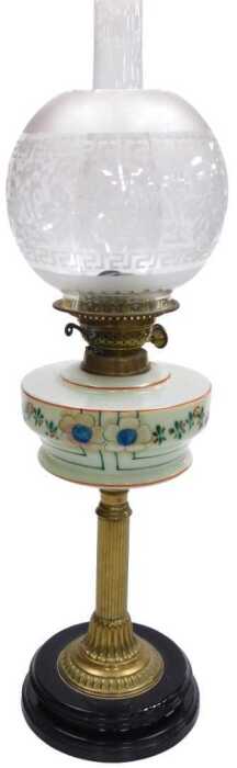 An early 20thC oil lamp, with a globular etched shade, an opaque cream glass reservoir decorated...