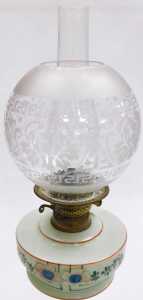 An early 20thC oil lamp, with a globular etched shade, an opaque cream glass reservoir decorated... - 2