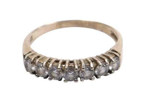 A 9ct gold and cz seven stone ring, in a claw set rub over setting, size P&frac12;, 2.0g.