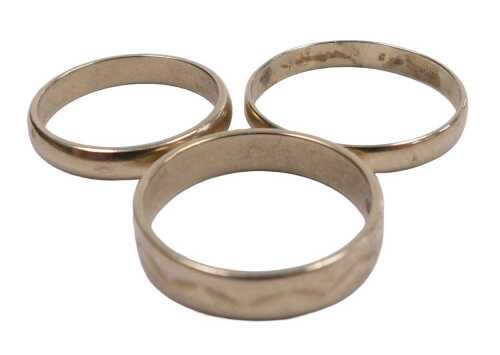A 9ct gold plain wedding band, size K, a 9ct gold wedding band, with engraved wavy decoration,...