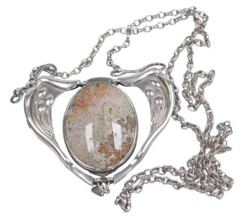 An Art Nouveau style silver and hardstone reversible necklace, set centrally with an agate, and...