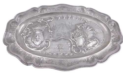 A Continental pewter meat dish or charger, cast with a crest, scrolls, flowers, etc., around a...