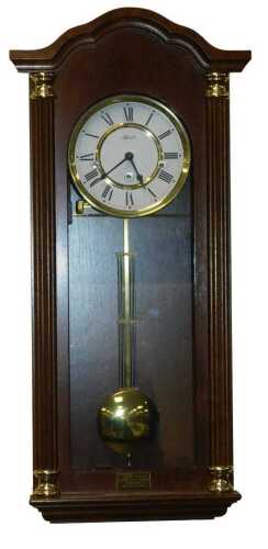 A late 20thC Hermle mahogany cased wall clock, circular brass dial with enamel chapter ring...