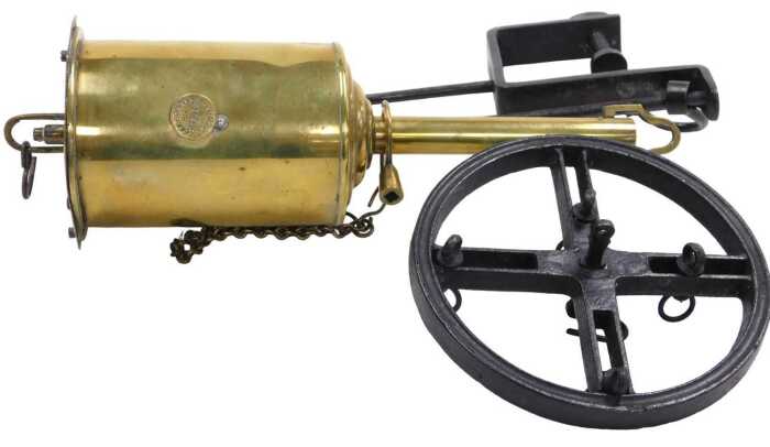 A 19thC brass Salter's Economical spitjack, with key, suspension rack, etc., 31cm long.