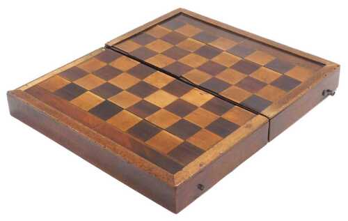 A Victorian mahogany and inlaid games box, with a chess board top, the hinged lid opening to...