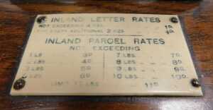 An early 20thC oak and brass set of postal scales, with ivorine plaque for Inland Letter Rates,... - 2