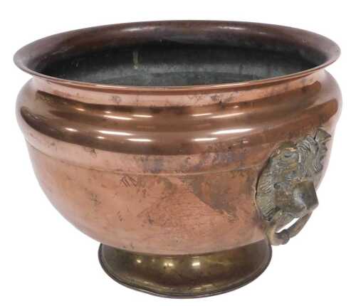 A 20thC copper and brass jardiniere, with lion's head and ring handles, 29cm wide.