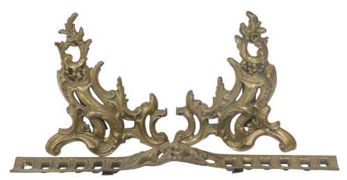 A late 19thC French brass chenet, of foliate scroll and floral form, 67cm wide.