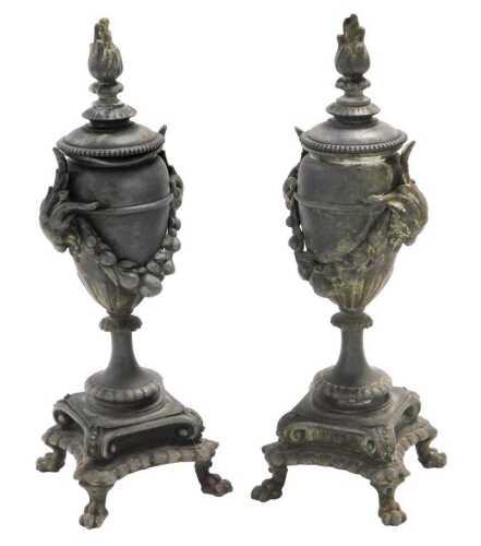 A pair of 19thC French pewter candlesticks, with reversible sconces, of urn form, with ram's...