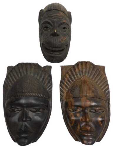 Two African tribal masks, each carved as a woman with a stylised headdress, 32cm high, and a...