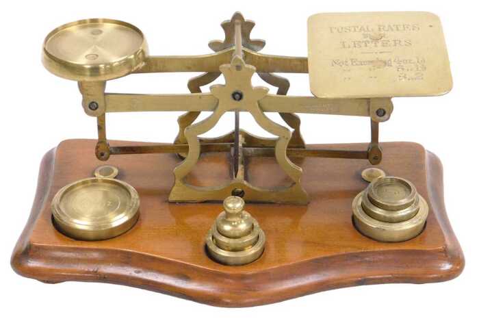A set of late 19th/early 20thC walnut and brass letter scales with weights, 20cm wide.