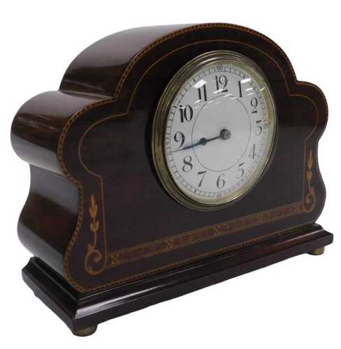 An Edwardian mahogany mantel clock, the circular enamel dial bearing Arabic numerals, clockwork...