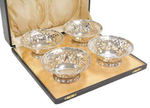 A set of four Edward VII silver pedestal sweetmeat dishes, with pierced decoration and beaded...