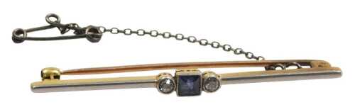 An early 20thC sapphire and diamond three stone bar brooch, with safety chain, as fitted, in...