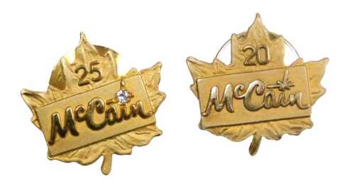 A McCain 20 years service pin, by Birks, yellow metal, stamped 10k, and 25 years service pin,...