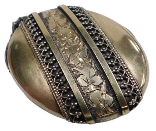 A Victorian double photo locket, of oval form, decorated with a diagonal band engraved with ivy,...
