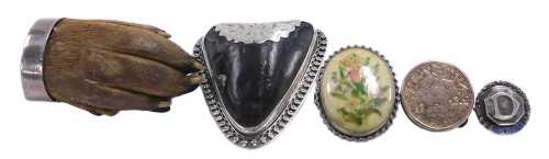 A silver mounted otter's paw brooch, two further brooches, a gold plated button, and a silver...