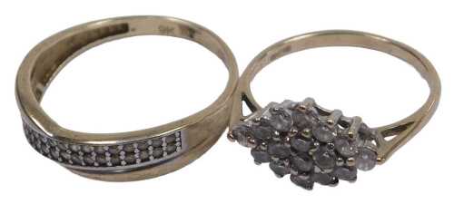 A 9ct gold and cubic zirconia band, in a crossover design, size P, and a 9ct gold and cubic...
